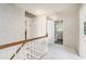Hallway with white wainscoting, wallpaper and white doors to bedrooms and bathroom at 1703 W Nancy Creek Ne Dr, Brookhaven, GA 30319
