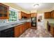 Functional kitchen boasting wooden cabinetry, tiled backsplash, and modern appliances, all bathed in sunlight at 1703 W Nancy Creek Ne Dr, Brookhaven, GA 30319
