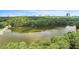 Scenic aerial view of lake surrounded by mature trees; skyline in the distance at 1703 W Nancy Creek Ne Dr, Brookhaven, GA 30319