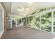 Bright and airy screened porch with carpet, skylights, and a ceiling fan offering an inviting outdoor retreat at 1703 W Nancy Creek Ne Dr, Brookhaven, GA 30319