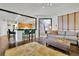 The open living room layout features a comfortable couch, eat-in bar, and bright lighting at 2295 Hemrick Rd, Cumming, GA 30041