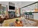 The open-concept living room has a fireplace, eat-in bar, and unique architectural details at 2295 Hemrick Rd, Cumming, GA 30041