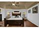 Comfortable bedroom features a tray ceiling, hardwood floors, a large bed, and two windows with natural light at 2295 Hemrick Rd, Cumming, GA 30041