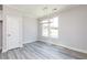Bright dining room with light gray walls, wood floors, a modern chandelier, and one large window at 2971 Beaconwood Ct, Lawrenceville, GA 30043