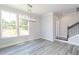Cozy dining room featuring light gray walls, wood floors, a modern chandelier, and a large window at 2971 Beaconwood Ct, Lawrenceville, GA 30043