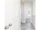Well lit hallway with white doors and wood-look floors at 2971 Beaconwood Ct, Lawrenceville, GA 30043