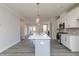Island kitchen is complete with modern appliances and an open concept living space at 2971 Beaconwood Ct, Lawrenceville, GA 30043