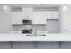 Stylish kitchen island features a stainless steel sink and pendant lights at 2971 Beaconwood Ct, Lawrenceville, GA 30043