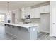 Island kitchen with white cabinets, quartz countertops and stainless appliances at 2971 Beaconwood Ct, Lawrenceville, GA 30043