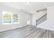 Bright living room with light gray walls, wood floors, ample windows, and a glass paned back door at 2971 Beaconwood Ct, Lawrenceville, GA 30043
