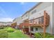 Spacious backyard featuring townhome exterior, green grass, and a wooden deck at 3542 Chattahoochee Summit Se Ln, Atlanta, GA 30339