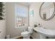 Well-lit half bathroom featuring modern fixtures, vanity with sink, and neutral decor at 3542 Chattahoochee Summit Se Ln, Atlanta, GA 30339