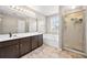 Spacious bathroom with a large vanity, soaking tub, and separate glass-enclosed shower at 3542 Chattahoochee Summit Se Ln, Atlanta, GA 30339