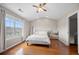 Bedroom featuring hardwood floors, a ceiling fan, and lots of natural light at 3542 Chattahoochee Summit Se Ln, Atlanta, GA 30339