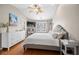 Comfortable bedroom showcasing a bed, white dresser, ceiling fan, and hardwood floors at 3542 Chattahoochee Summit Se Ln, Atlanta, GA 30339