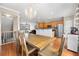 Inviting dining area with wood table, chandelier, and open view of the kitchen at 3542 Chattahoochee Summit Se Ln, Atlanta, GA 30339