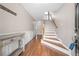 Inviting foyer with staircase, hardwood floors, and decorative console table at 3542 Chattahoochee Summit Se Ln, Atlanta, GA 30339