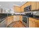 Kitchen features stainless appliances, wood cabinets and granite countertops at 3542 Chattahoochee Summit Se Ln, Atlanta, GA 30339