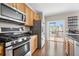Well-lit kitchen featuring stainless steel appliances and sliding door to the deck at 3542 Chattahoochee Summit Se Ln, Atlanta, GA 30339