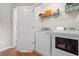 Convenient laundry room featuring new washer and dryer and shelving at 3542 Chattahoochee Summit Se Ln, Atlanta, GA 30339
