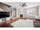 Spacious living room showcasing hardwood floors, a fireplace and a ceiling fan at 3542 Chattahoochee Summit Se Ln, Atlanta, GA 30339