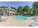 Community pool area with lots of chairs and umbrella-covered tables on a sunny day at 3542 Chattahoochee Summit Se Ln, Atlanta, GA 30339