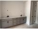 Bathroom featuring double sinks, gray cabinets, sleek countertops, and ample storage space at 3104 Marbella Cir # 2, Kennesaw, GA 30152