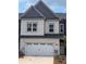 Charming two-story townhome with a one car garage, gray brick, and gray trim at 3104 Marbella Cir # 2, Kennesaw, GA 30152