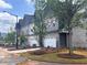 Row of newly built two-story townhomes with light landscaping at 3104 Marbella Cir # 2, Kennesaw, GA 30152