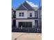 Charming townhome with a white brick facade and an attached two-car garage at 3104 Marbella Cir # 2, Kennesaw, GA 30152