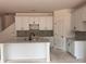 New kitchen boasts an island with a sink, white cabinets, and tiled backsplash, enhancing its modern appeal at 3104 Marbella Cir # 2, Kennesaw, GA 30152