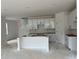An unfinished kitchen features white cabinets, a central island, and a door to the side at 3104 Marbella Cir # 2, Kennesaw, GA 30152