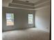 Spacious primary bedroom featuring a tray ceiling and large windows for ample natural light at 3104 Marbella Cir # 2, Kennesaw, GA 30152