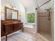 Bathroom featuring a tub and shower combo, with natural light from the window at 3774 Seasons Nw Dr, Acworth, GA 30101