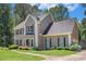 Beautiful home with a manicured lawn, colorful flowerbeds, and a welcoming walkway at 3774 Seasons Nw Dr, Acworth, GA 30101