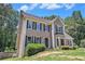 View of a charming home with a manicured lawn and lush landscaping at 3774 Seasons Nw Dr, Acworth, GA 30101