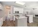 Bright, white kitchen boasts stainless appliances, granite counters, and central island for ample workspace at 3774 Seasons Nw Dr, Acworth, GA 30101