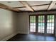 Open room with exposed beams and doors that lead to the backyard pool at 3774 Seasons Nw Dr, Acworth, GA 30101