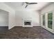 Open living room with a marble fireplace, ceiling fan, and large windows at 3774 Seasons Nw Dr, Acworth, GA 30101