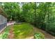 Exterior view of a lush backyard, basketball hoop, and two car driveway for parking at 4219 Harrogate Nw Dr, Atlanta, GA 30327