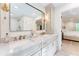 Bright bathroom featuring double vanity, stone countertops, and gold fixtures at 4219 Harrogate Nw Dr, Atlanta, GA 30327