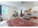 Bright bedroom featuring a patterned red rug, a canopy bed, and a ceiling fan at 4219 Harrogate Nw Dr, Atlanta, GA 30327