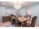 Elegant dining room with a unique chandelier and a view into the adjacent kitchen at 4219 Harrogate Nw Dr, Atlanta, GA 30327