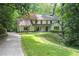 Beautiful home with lush landscaping, mature trees, and a long driveway at 4219 Harrogate Nw Dr, Atlanta, GA 30327