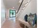 Bright foyer featuring wood floors, a stylish bench with plush pillows, and a staircase at 4219 Harrogate Nw Dr, Atlanta, GA 30327