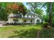 Charming two-story home featuring a well-manicured lawn and a classic painted brick facade at 4219 Harrogate Nw Dr, Atlanta, GA 30327