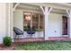 Front porch with decorative chairs, a chandelier, and a brick foundation at 4219 Harrogate Nw Dr, Atlanta, GA 30327