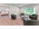 Spacious living room with a view into the bedroom, comfortable chairs, and natural light at 4219 Harrogate Nw Dr, Atlanta, GA 30327