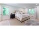 Comfortable bedroom with hardwood floors, neutral color scheme, and great natural light from large windows at 4219 Harrogate Nw Dr, Atlanta, GA 30327