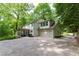 Exterior of home featuring a screened-in porch and view of the lush backyard at 4219 Harrogate Nw Dr, Atlanta, GA 30327